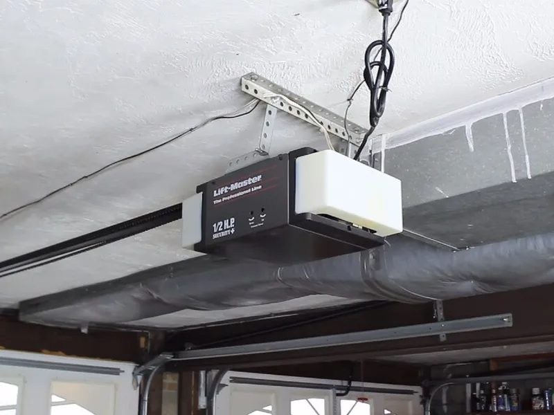 Chain-drive garage door opener unit mounted on a garage ceiling